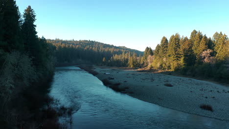 water flowing in smith river with coniferous forest in summer in humboldt county, california, usa