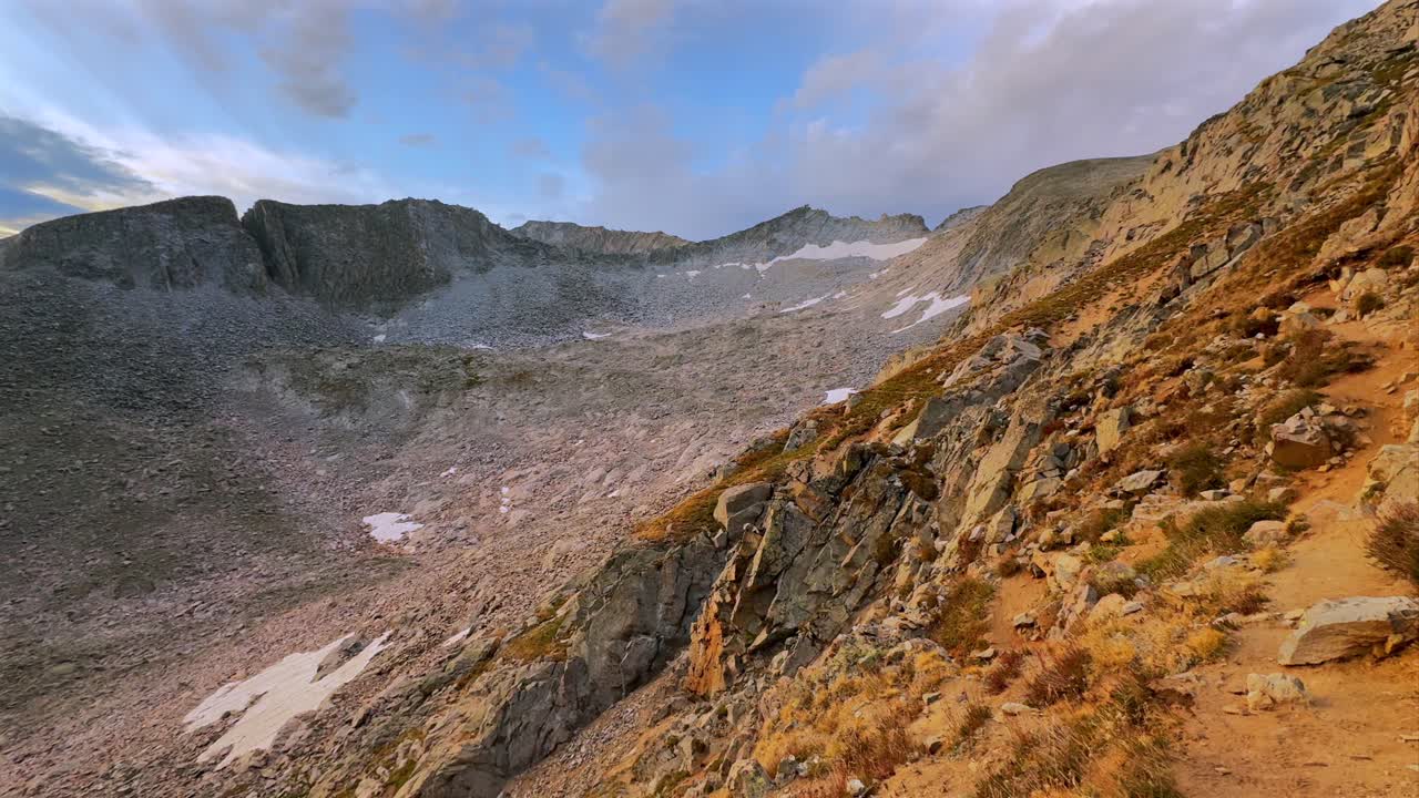Aspen Snowmass Wilderness vibrant sunrise snow glacier melt Capitol Peak Trailhead Ridge route Mt Daly K2 Colorado Rocky Mountain Elk Range landscape high alpine elevation clouds pan left motion