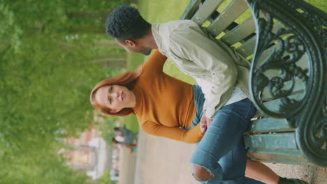 vertical video of couple of vloggers or social influencers travelling in city park for social media