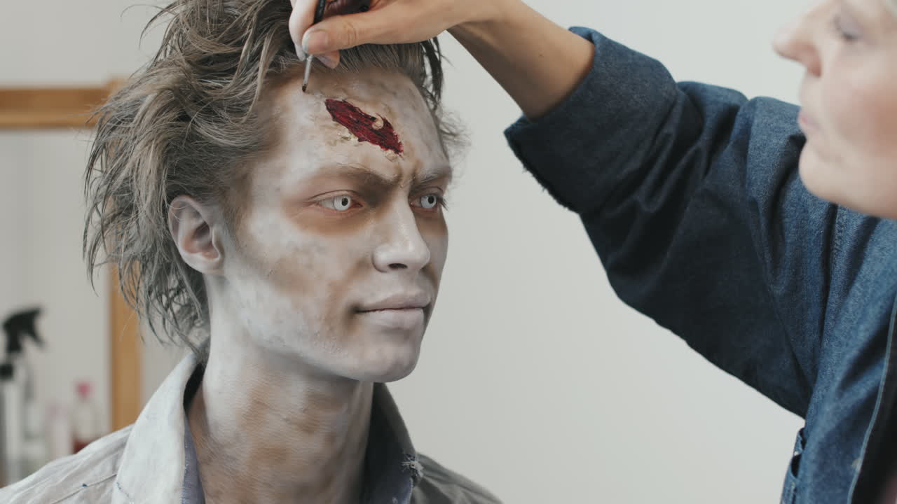 SFX Artist Doing Zombie Makeup on Man
