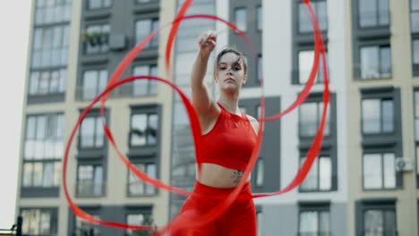 woman twirling red ribbons outdoors