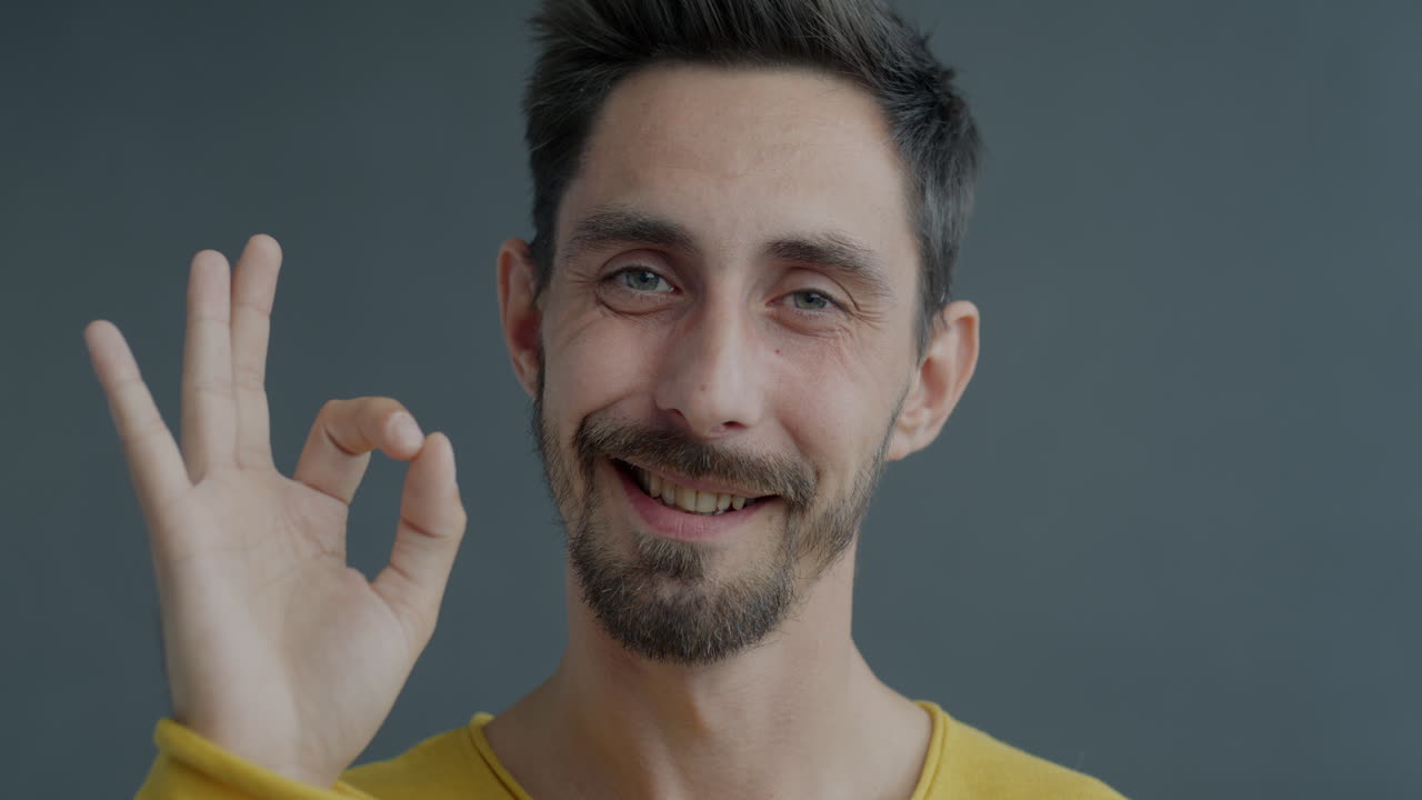 Man Smiling and Making an Ok Sign