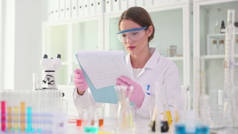 female scientist working and analyzing data in a laboratory