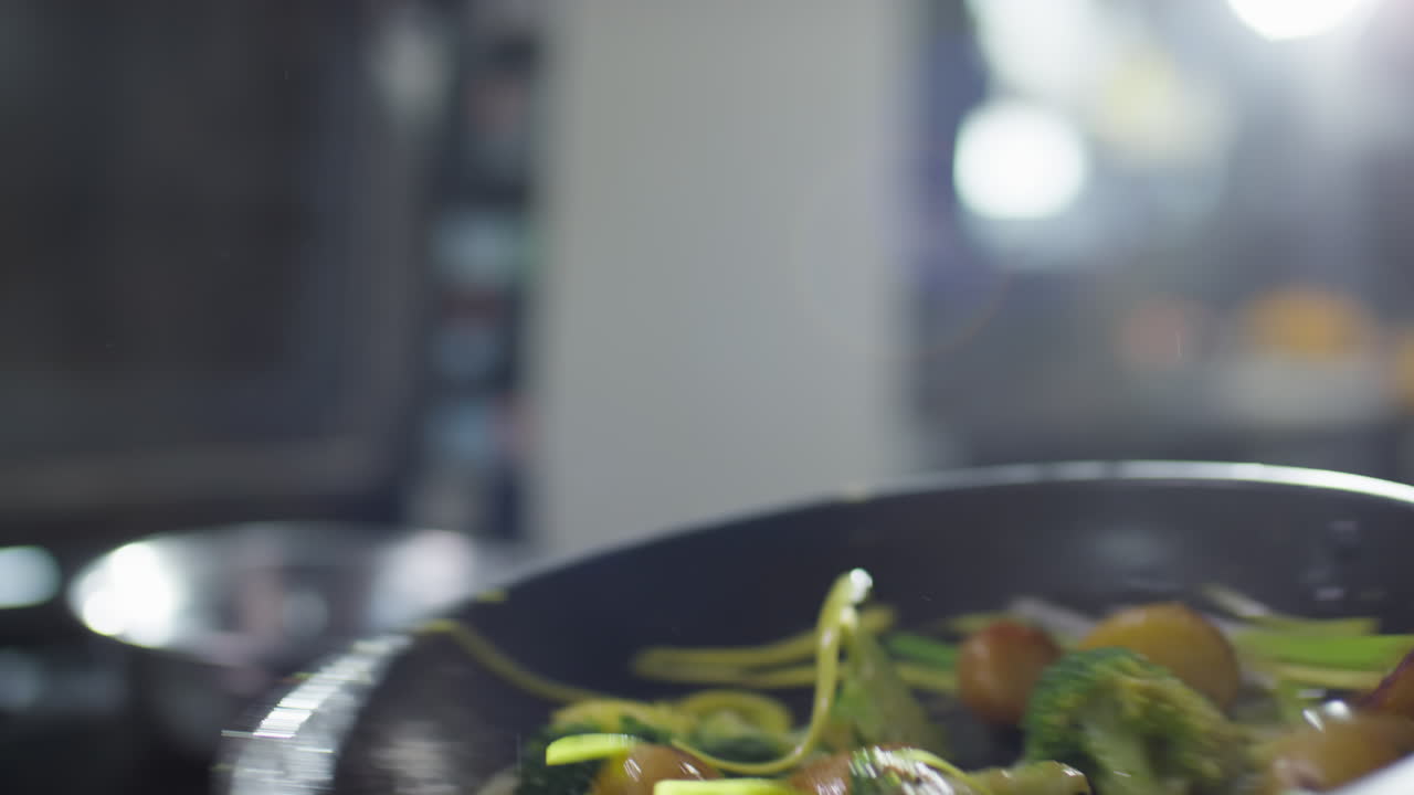 Tossing Veggies on Skillet