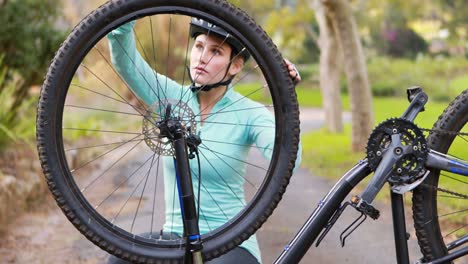 female cyclist repairing bicycle tyre