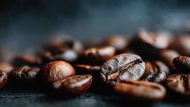 Captivating Imagery of Roasted Coffee Beans with Aromatic Steam Rising, Showcasing the Richness and Texture of Each Bean in a Lush, Dark Setting