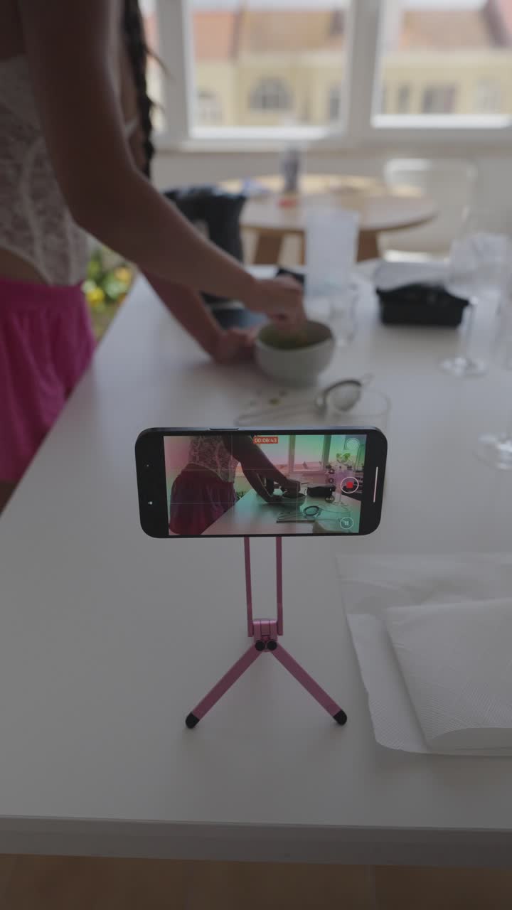 Woman Cooking and Vlogging in Kitchen