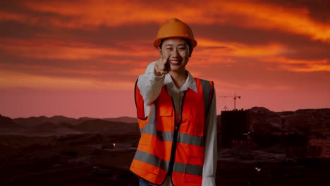 confident female engineer at sunset construction site