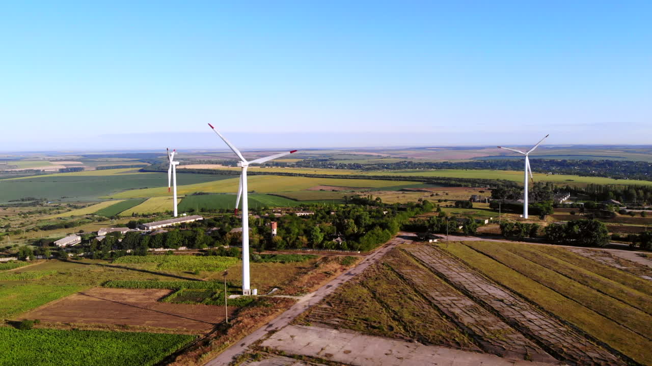Aerial drone shot of three wind turbines located on a field near Donduseni in Moldova