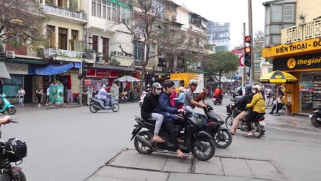 motorbikes and pedestrians in a busy intersection