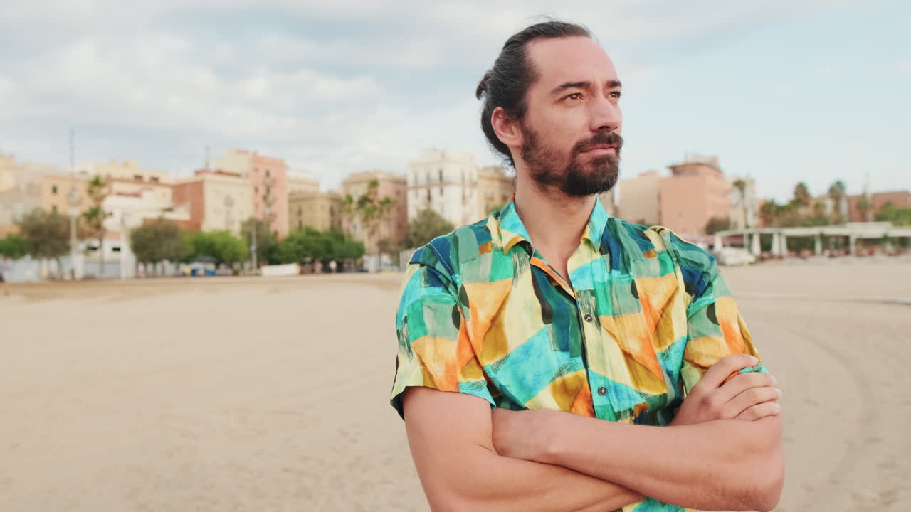 Man Standing on Beach with Cityscape