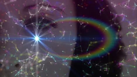 Animation of glowing spot and network of connections over woman&#039;s face