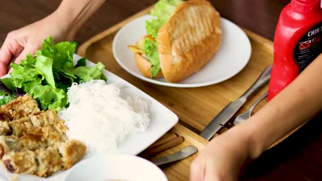 a meal with pork bun and accompaniments