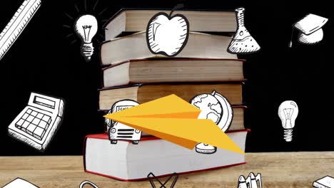 animación de los iconos de los artículos escolares sobre los libros en el escritorio