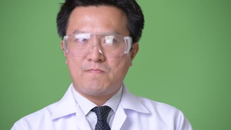 mature japanese man doctor wearing protective glasses