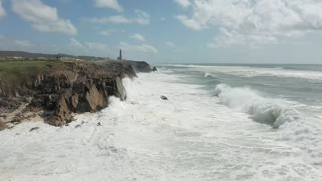 static view of heavy waves slamming into cliffs along coastline