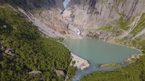 scenic briksdalsbreen glacier in norway, scandinavia with thick ice and lake. epic mountain nature aerial.