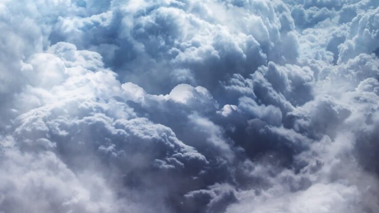 The point of view is moving towards the thick, dark cumulus cloud
