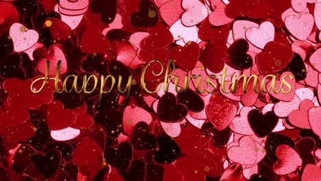 animation of happy christmas text over glowing pink hearts