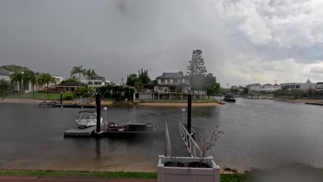 dark clouds gather over waterfront homes and docks