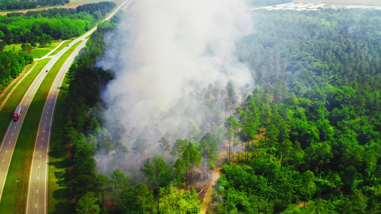 Aerial View of Wildfire in Georgia Forest Near Highway With Thick Smoke Columns. USA