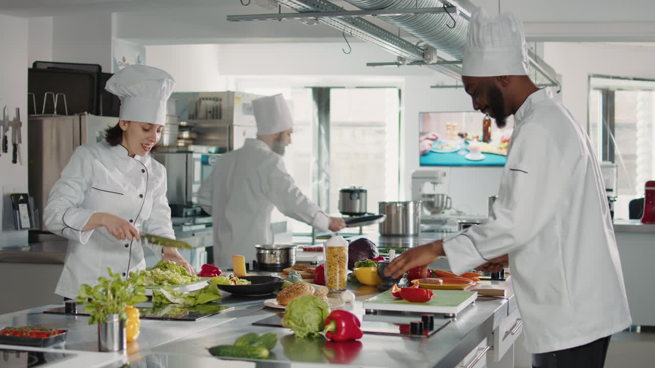 Man and woman cutting fresh ingredients to make gourmet dish
