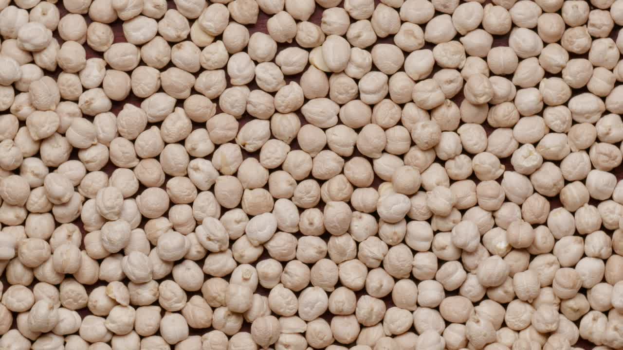Group of raw chickpeas rotating in а circle
