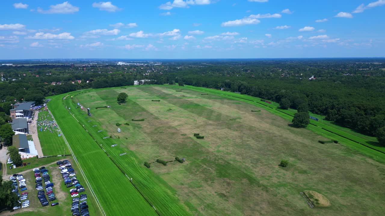horse racing track with spectators enjoying the competition on a sunny summer day. Magic aerial view flight panorama overview drone