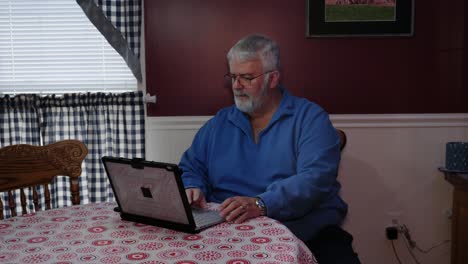 Senior Citizen Happy Using a Computer and Technology to do Daily Activities