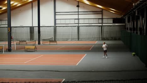 indoor tennis court with player