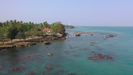 coastal view with lighthouse and houses