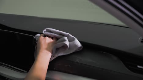 a man wiping off dashboard cleaner with a microfiber towel