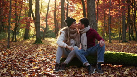 a young couple shares intimate moments in a beautiful autumn forest