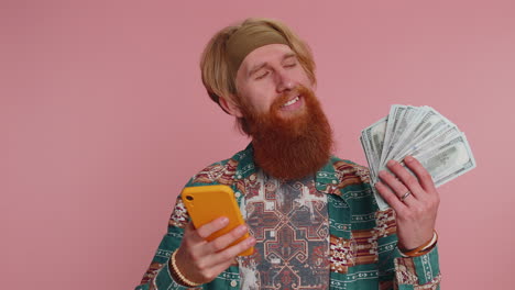 happy man with cash and phone