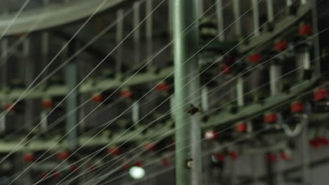 automated cotton knitting machinery in operation with numerous cotton threads pulled inside in a textile factory in china