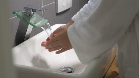 Woman-washing-hands-with-liquid-soap