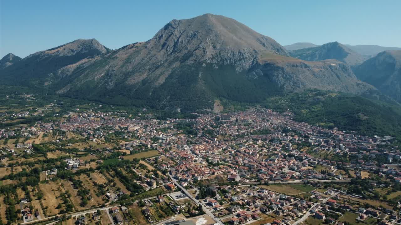 Aerial View of Town Under Mountain Range