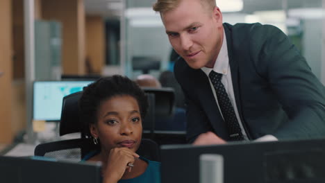 businessman meeting with colleague using computer team leader man pointing at screen helping coworker discussing strategy in corporate workplace