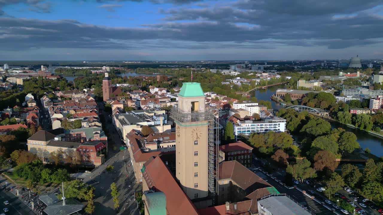 Aerial view showing Rathaus Spandau in old town, buildings, subway station, and public transportation in Berlin. Breathtaking aerial view flight panorama orbit drone