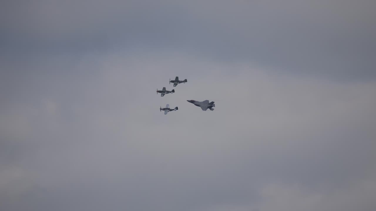 The F-35 military fighter aircraft flies through the air in a beautiful formation next to each other at the air show called Airpower with other three aerobatic pilots. Slow motion