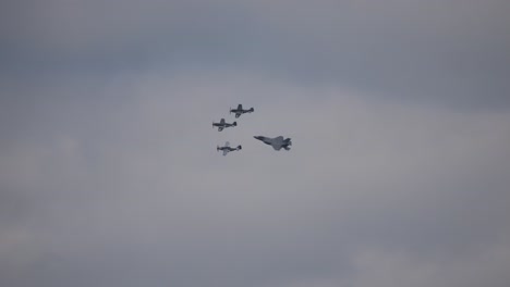 the f-35 military fighter aircraft flies through the air in a beautiful formation next to each other at the air show called airpower with other three aerobatic pilots. slow motion