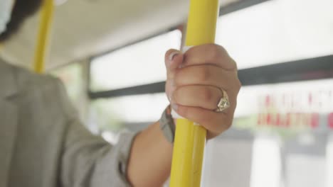 plus size biracial woman wearing face mask in bus