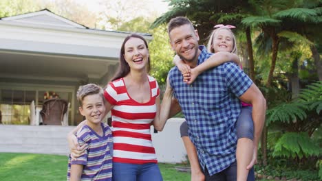 Portrait-of-happy-caucasian-parents,-son-and-daughter-standing-in-garden-together