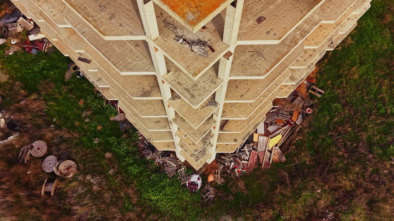 Aerial view of abandoned building surrounded by overgrown vegetation