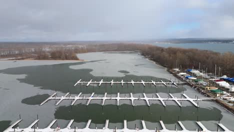 aerial pulling out from a snow covered winter dock.