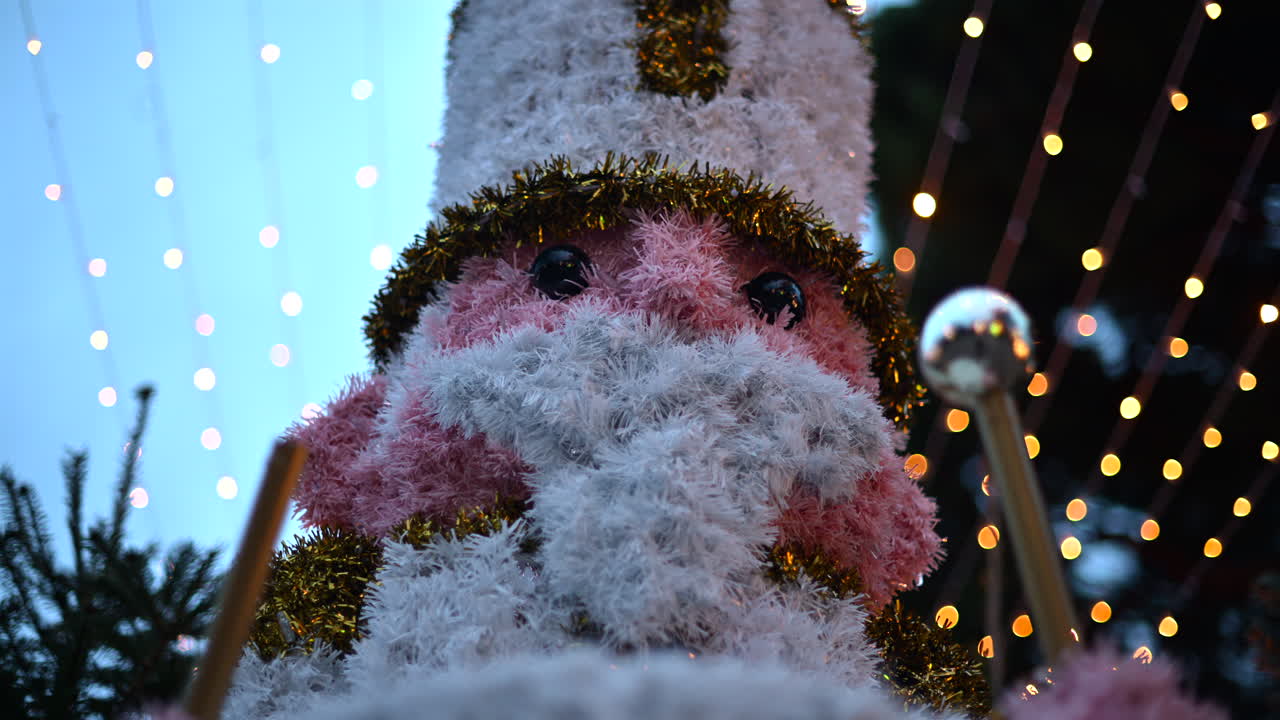 Decorative Christmas nutcracker soldier figure displayed outdoors with trees in the background