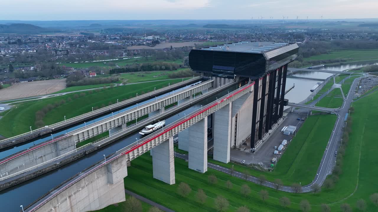 Fixed aerial shot showing a boat moving along the upper canal of the Strépy-Thieu boat lift in Le Roeulx during blue hour