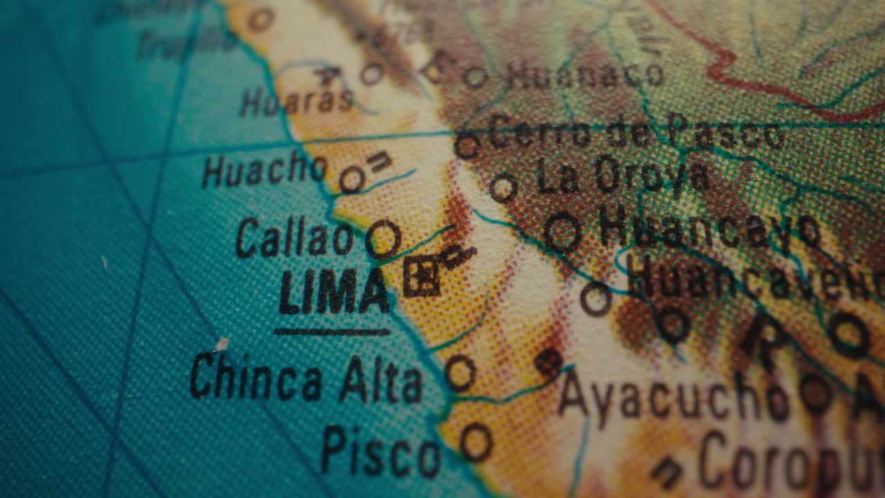 Close-up of a world map, focusing on Lima, Peru