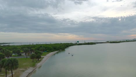 sunrise over the banana river in florida with kayakers