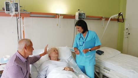 senior couple interacting with female doctor